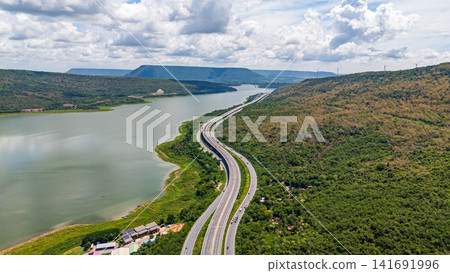 Drone shot The M6 motorway Nakhon Ratchasima Province - Bang Pa-in Lam Ta Khong River and Mountain. Motorway Korat Thailand Drone shot The M6 motorway Nakhon Ratchasima Province - Bang Pa-in Lam Ta Khong River and Mountain. Motorway Korat Thailand 141691996