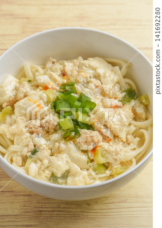 Udon noodles with a thick sauce made from ground chicken and tofu. Udon noodles with a thick sauce made from ground chicken and tofu. 141692280