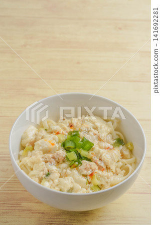 Udon noodles with a thick sauce made from ground chicken and tofu. Udon noodles with a thick sauce made from ground chicken and tofu. 141692281