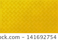An elegant gold leaf background featuring a traditional "weight" motif in relief. 141692754