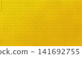 An elegant gold leaf background featuring a traditional "weight" motif in relief. 141692755