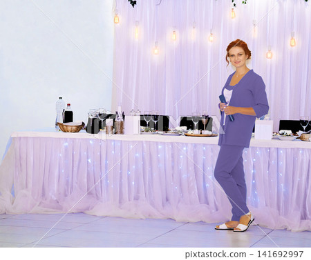 Host toastmaster near festive table waiting of newlyweds birthday quests Host toastmaster near festive table waiting of newlyweds birthday quests 141692997