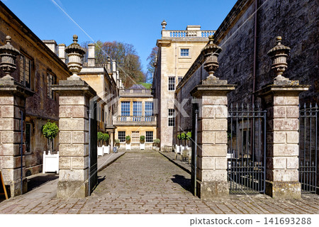 Grand stone gate pillars leading into the historic courtyard stable yard at Dyrham Park, England Grand stone gate pillars leading into the historic courtyard stable yard at Dyrham Park, England 141693288