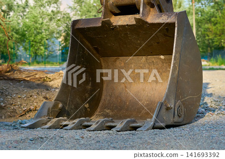 Big excavator bulldozer bucket on construction site Big excavator bulldozer bucket on construction site 141693392