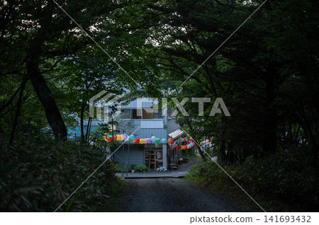 An outdoor facility surrounded by a deep forest and a landscape adorned with enchanting lanterns. An outdoor facility surrounded by a deep forest and a landscape adorned with enchanting lanterns. 141693432
