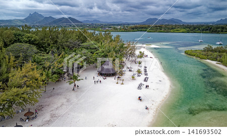Aerial high angle shot of the sandbar beach, turquoise lagoon channel, and anchored boats at Ile aux Cerfs, Mauritius Aerial high angle shot of the sandbar beach, turquoise lagoon channel, and anchored boats at Ile aux Cerfs, Mauritius 141693502