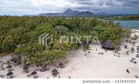 Aerial high angle shot of the sandbar beach, turquoise lagoon channel, and anchored boats at Ile aux Cerfs, Mauritius Aerial high angle shot of the sandbar beach, turquoise lagoon channel, and anchored boats at Ile aux Cerfs, Mauritius 141693503