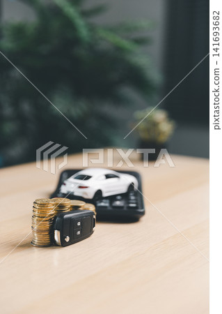 Car key and stacked coins with miniature car and calculator, representing auto loan repayment, car insurance cost, vehicle ownership, and transportation finance. Car key and stacked coins with miniature car and calculator, representing auto loan repayment, car insurance cost, vehicle ownership, and transportation finance. 141693682