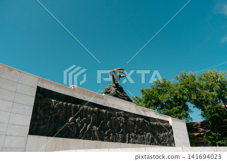 Monument to Fallen Soldiers and Victims of Fascism in Subotica, Serbia under clear blue sky. Memorial sculpture honors wartime sacrifice and remembrance Monument to Fallen Soldiers and Victims of Fascism in Subotica, Serbia under clear blue sky. Memorial sculpture honors wartime sacrifice and remembrance 141694023
