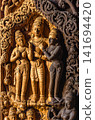 Wood carving of three deity figures beneath foliage motifs at Sanctuary of Truth 141694420