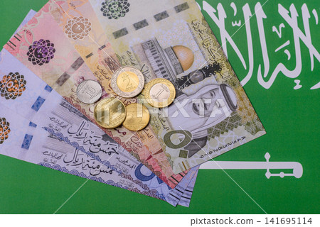 Saudi Arabia paper money, riyal banknotes and coins as currency for exchange. Saudi Arabia money Saudi Arabia paper money, riyal banknotes and coins as currency for exchange. Saudi Arabia money 141695114