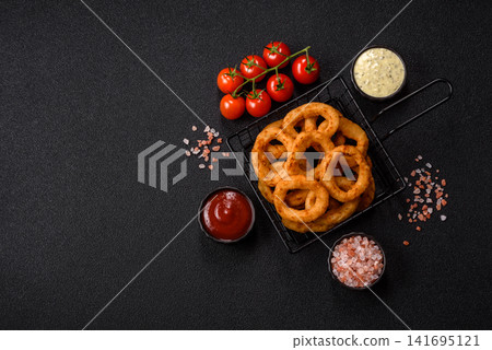 Deep fried breaded onion or squid rings, crispy fast food snacks. Fried onion or squid rings Deep fried breaded onion or squid rings, crispy fast food snacks. Fried onion or squid rings 141695121