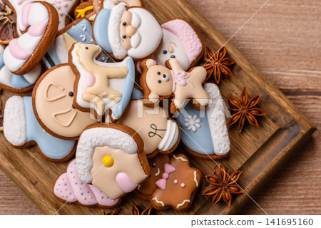 Gingerbread as a Christmas staple, sweet biscuits for the holiday. Gingerbread as a background Gingerbread as a Christmas staple, sweet biscuits for the holiday. Gingerbread as a background 141695160