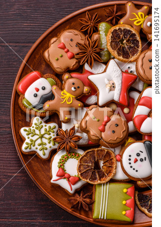Gingerbread as a Christmas staple, sweet biscuits for the holiday. Gingerbread as a background Gingerbread as a Christmas staple, sweet biscuits for the holiday. Gingerbread as a background 141695174