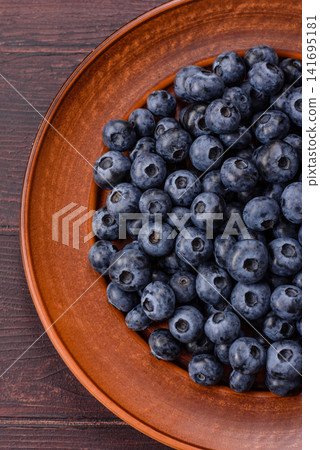 Fresh, ripe, and juicy wild blueberries as an ingredient for vegetarian dishes Fresh, ripe, and juicy wild blueberries as an ingredient for vegetarian dishes 141695181