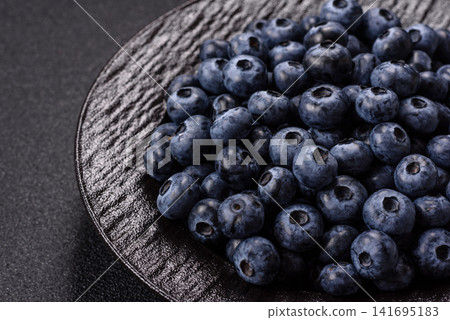 Fresh, ripe, and juicy wild blueberries as an ingredient for vegetarian dishes Fresh, ripe, and juicy wild blueberries as an ingredient for vegetarian dishes 141695183