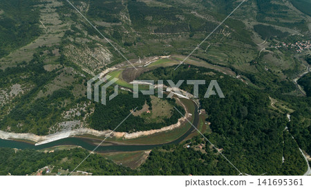 Aerial view of a winding river and green hills in Stara Planina National Park, Serbia Aerial view of a winding river and green hills in Stara Planina National Park, Serbia 141695361