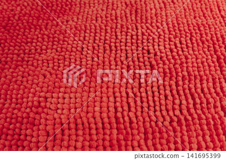 Detailed close up texture of soft red textile material with raised pattern. Modern fabric and interior decoration concept Detailed close up texture of soft red textile material with raised pattern. Modern fabric and interior decoration concept 141695399