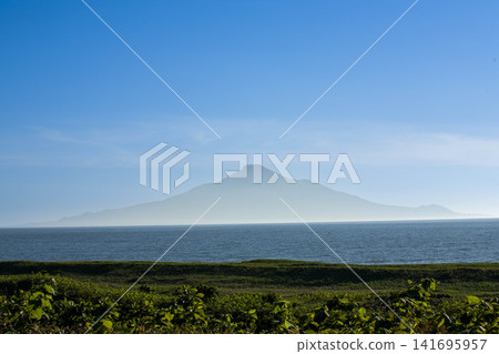 Rishiri Island as seen from Hokkaido: a breathtaking view of the blue sea and majestic volcano. Rishiri Island as seen from Hokkaido: a breathtaking view of the blue sea and majestic volcano. 141695957