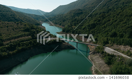 Scenic aerial view of Zavoj Lake with a bridge crossing between green forested mountains in Serbia Stara Planina National Park Scenic aerial view of Zavoj Lake with a bridge crossing between green forested mountains in Serbia Stara Planina National Park 141696038