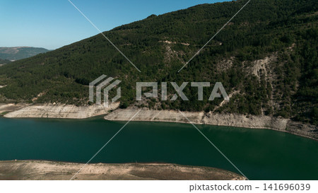 Aerial view of Zavoj Lake in Stara Planina National Park, Serbia, with turquoise water surrounded by green mountains Aerial view of Zavoj Lake in Stara Planina National Park, Serbia, with turquoise water surrounded by green mountains 141696039