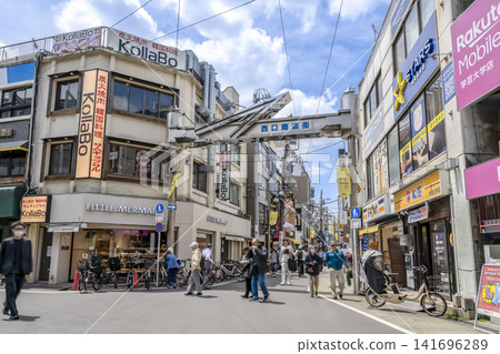 Urban scenery of Meguro Ward, Tokyo: Entrance to the shopping street and shops at the west exit of Gakugei-daigaku Station. Urban scenery of Meguro Ward, Tokyo: Entrance to the shopping street and shops at the west exit of Gakugei-daigaku Station. 141696289