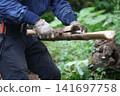 Man splitting bamboo 141697758