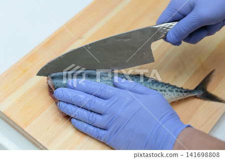 A woman's hands preparing mackerel 141698808