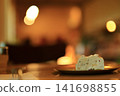 Candles and cake placed on the table 141698855
