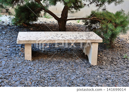 Minimalist Stone Bench in Japanese Garden with Pine Tree. Minimalist Stone Bench in Japanese Garden with Pine Tree. 141699014