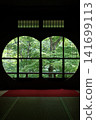 Fresh greenery seen through a round window 141699113