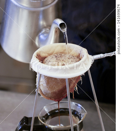 Brewing coffee in the kitchen Brewing coffee in the kitchen 141699674
