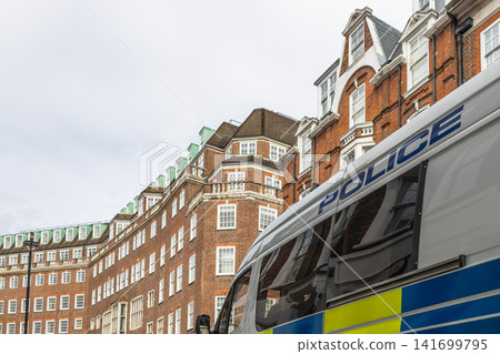 UK police vehicle on patrol near residential buildings UK police vehicle on patrol near residential buildings 141699795