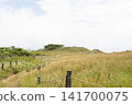 A hill with a grassland and a wooden fence. 141700075