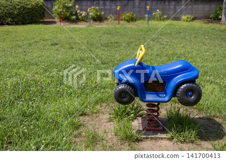 A park on a sunny day with blue spring playground equipment (horizontal composition) 141700413