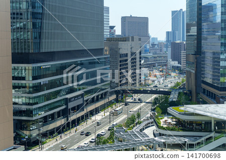 The modern cityscape of high-rise office buildings and tower apartments in Osaka's Umeda district stands out against the blue sky. The modern cityscape of high-rise office buildings and tower apartments in Osaka's Umeda district stands out against the blue sky. 141700698