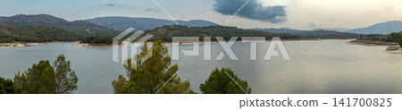 Beniarres reservoir view surrounded by hills and mountains in Alicante Spain at sunset Beniarres reservoir view surrounded by hills and mountains in Alicante Spain at sunset 141700825
