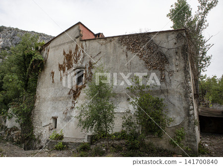 Historic Spanish hacienda stands abandoned among wild nature and green foliage in a forgotten area Historic Spanish hacienda stands abandoned among wild nature and green foliage in a forgotten area 141700840