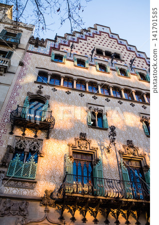Casa Amatller, an artistic building in the streets of Barcelona, Spain, bathed in the orange light of the sunrise. 141701585