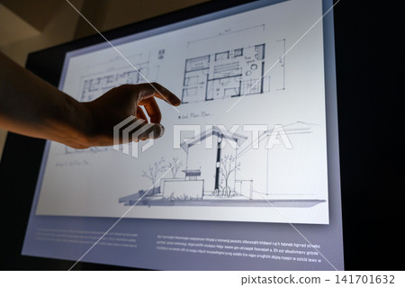 Checking architectural drawings on a tablet Checking architectural drawings on a tablet 141701632