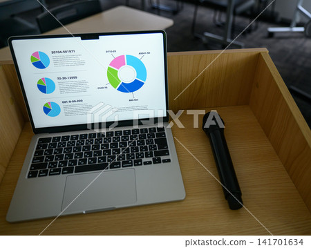 A laptop and microphone placed on the podium 141701634