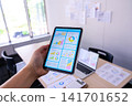 Tablet and laptop screens held in the hand 141701652