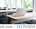 A laptop computer is placed on a desk in the classroom. 141701654
