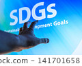 Business professionals pointing to the SDGs and a sustainable future 141701658
