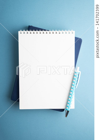 Blank Notepad and Pen Lay Flat on Textured Blue Background Ready for Design Blank Notepad and Pen Lay Flat on Textured Blue Background Ready for Design 141702399