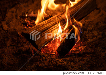 The firewood burns brightly in the hearth. The firewood burns brightly in the hearth. 141702609
