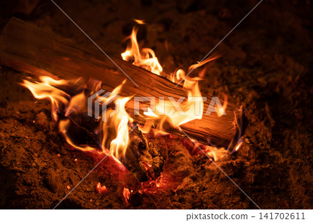 The firewood burns brightly in the hearth. The firewood burns brightly in the hearth. 141702611