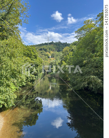Scenic view of the Wupper river with Diederichstempel pavilion on the forested hill, Solingen, Germany 141703075