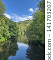 Sky and forest reflected in Wupper river valley near Solingen, Germany 141703207