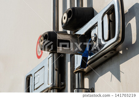 Vertical profile view of a locked delivery truck door mechanism Vertical profile view of a locked delivery truck door mechanism 141703219